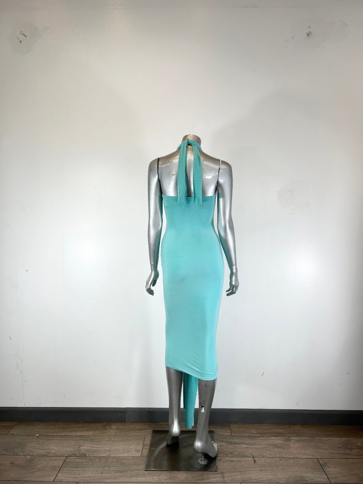 Aqua halter bodycon midi dress on mannequin, open back with thin tie straps