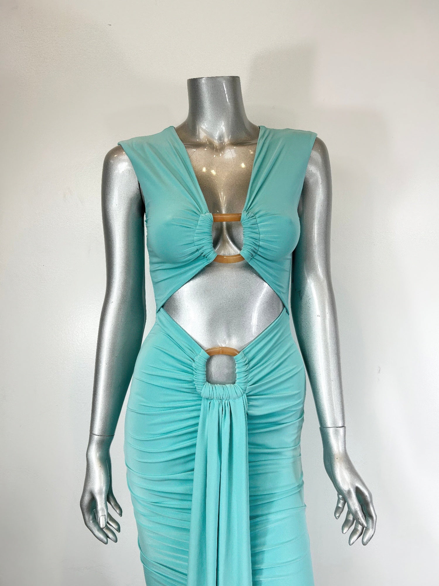 Aqua bodycon midi dress on mannequin: deep V, ring cut-outs, ruched skirt