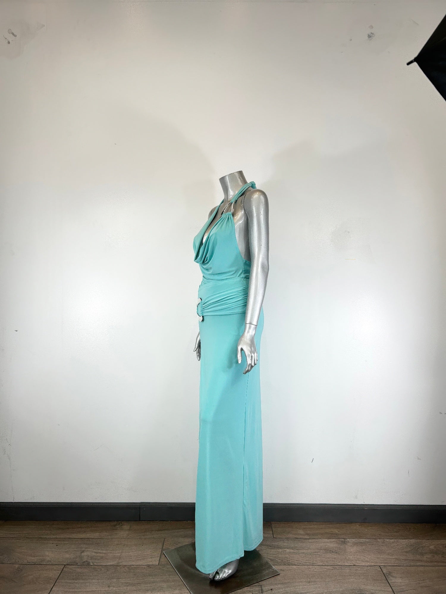 Aqua halter dress set on mannequin, draped bodice and back tie