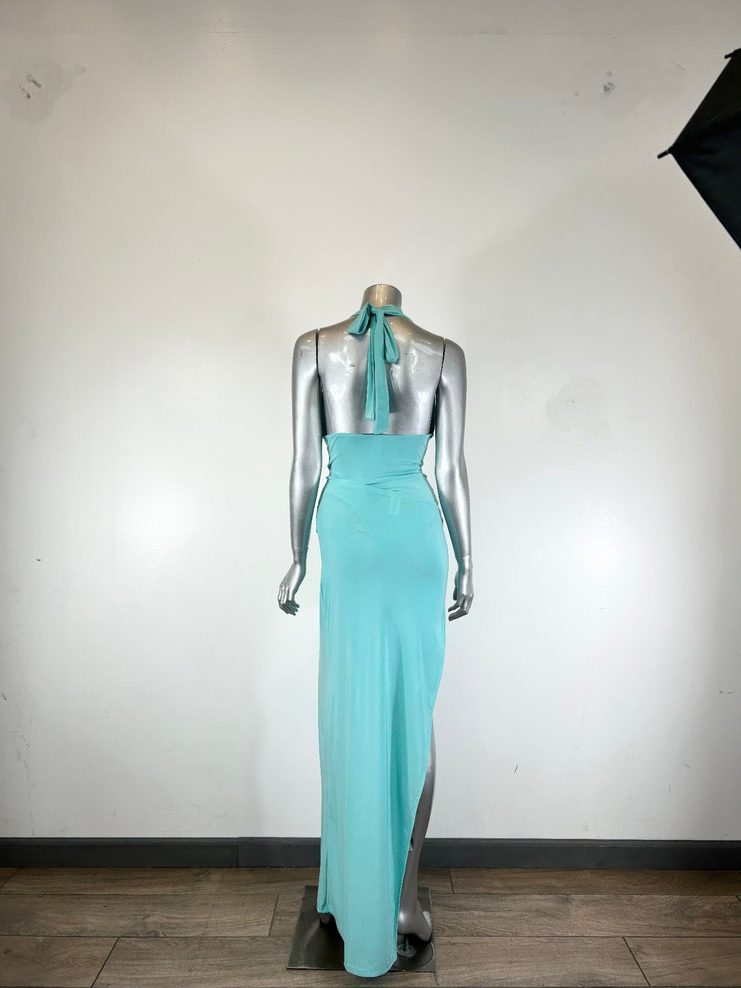Aqua halter back view on mannequin, open back with ribbon tie and long skirt