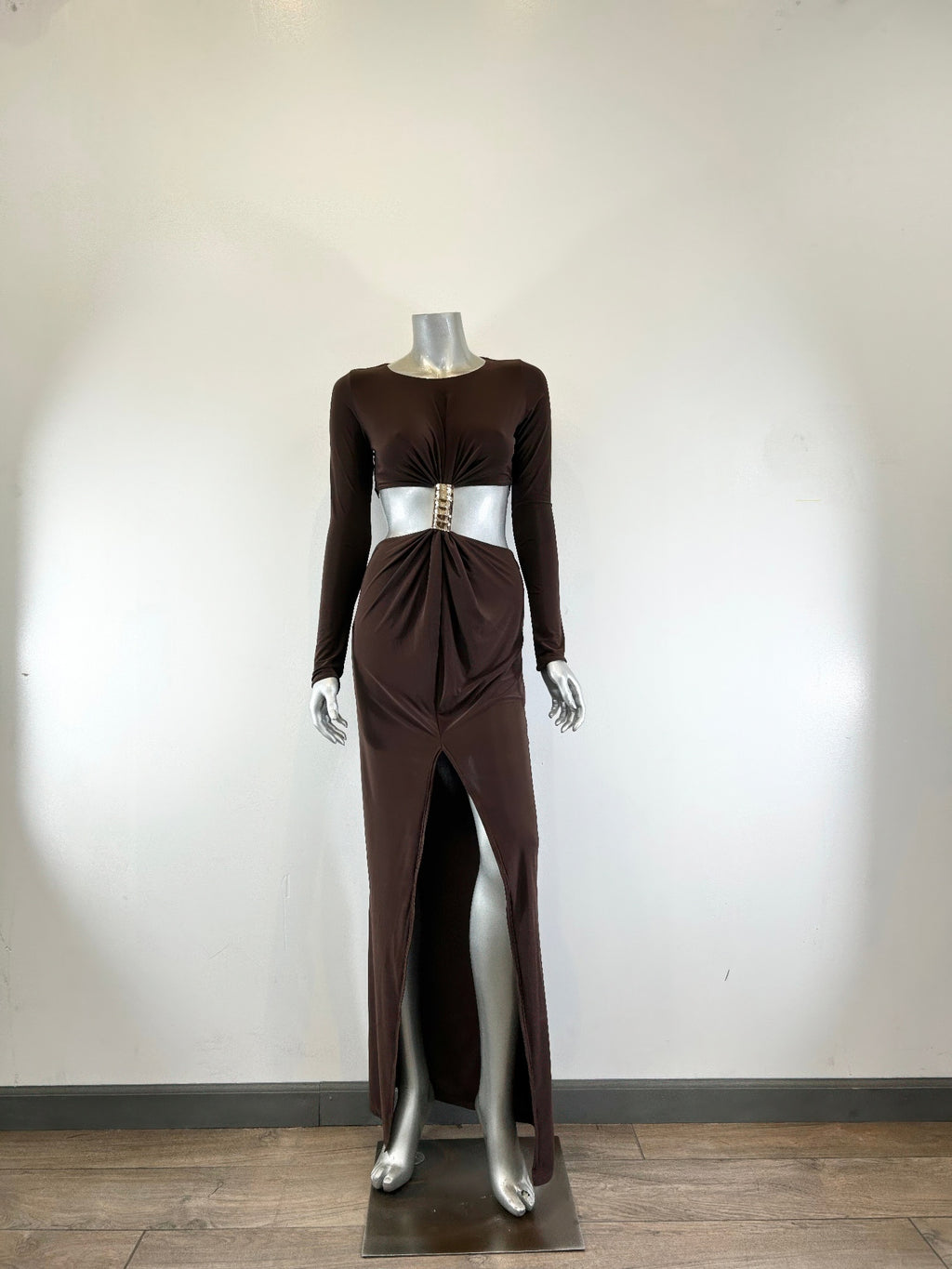 Dark brown mockneck maxi dress on mannequin, draped front with gold belt buckle