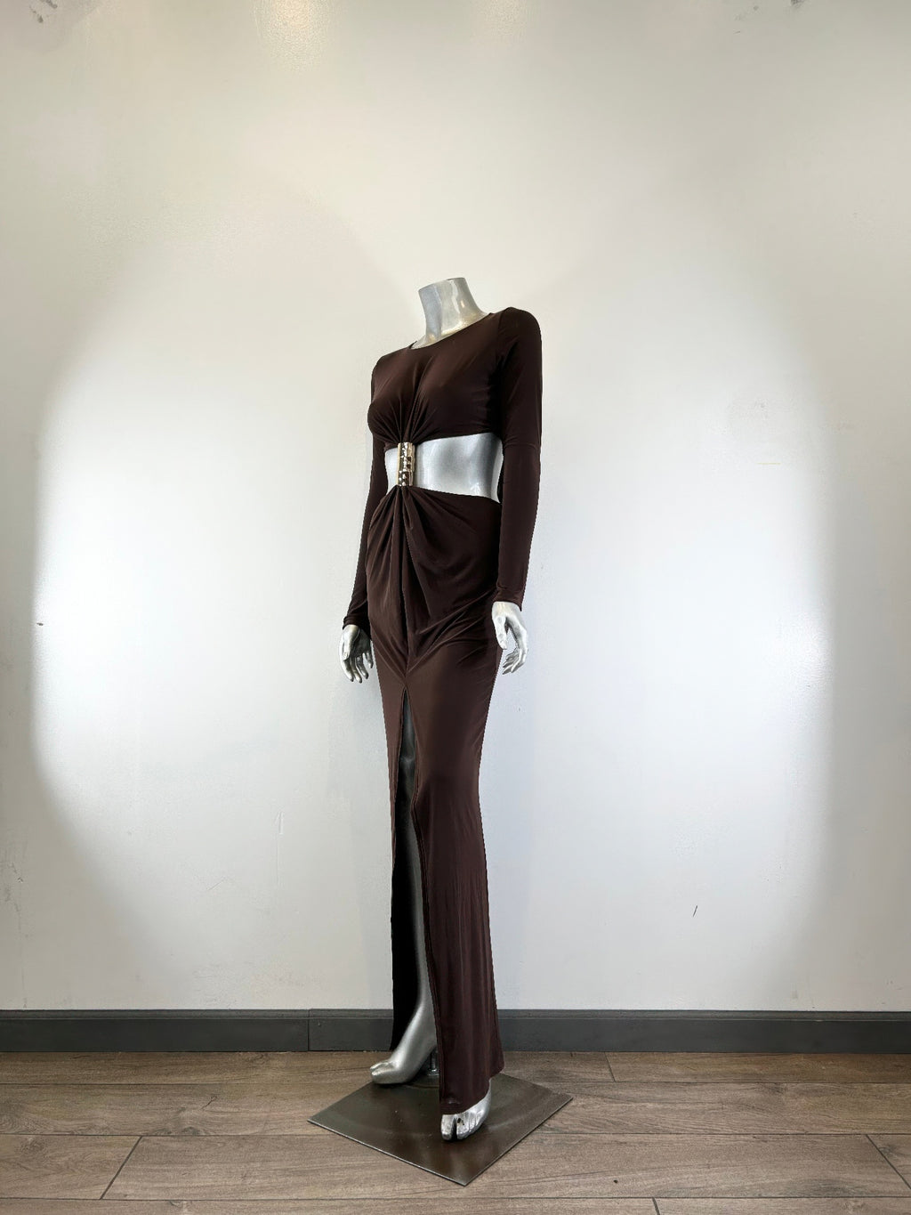 Dark brown mockneck maxi dress on mannequin, side view with cinched waist and long slit