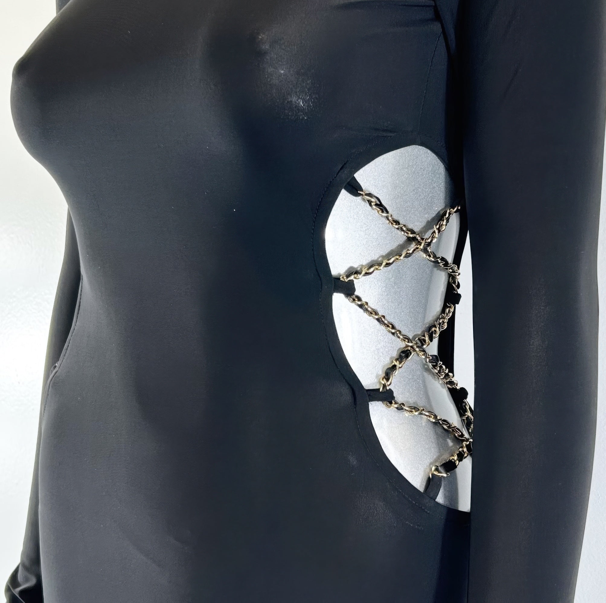 Black dress torso with oval cutout and gold-tone chain detail