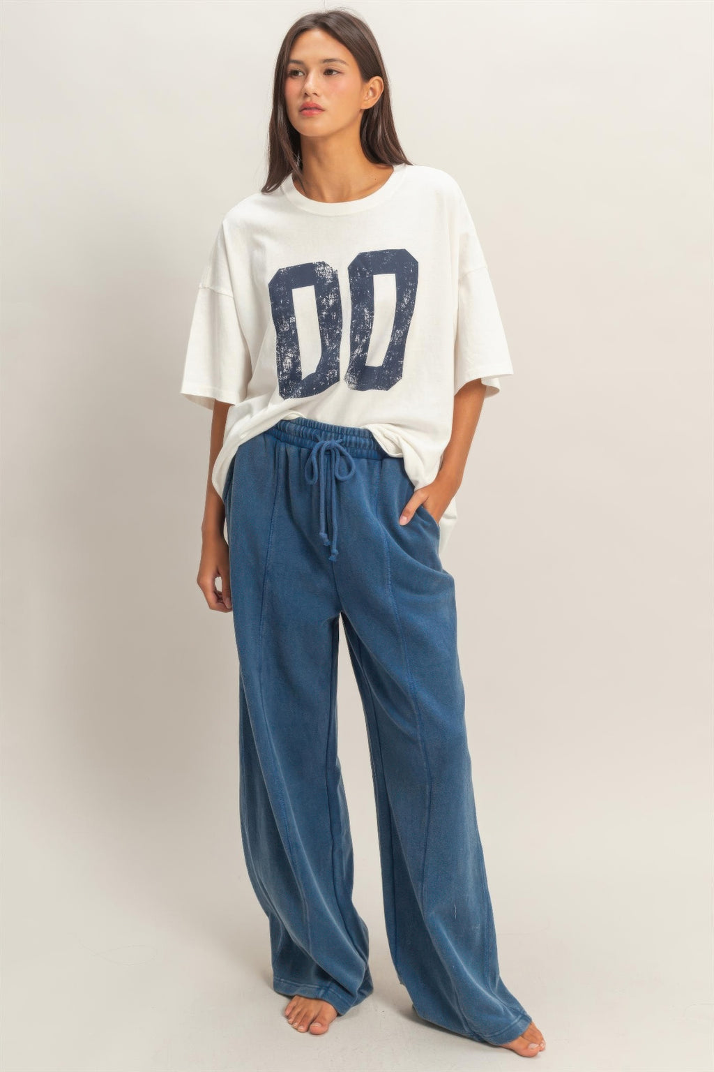 Blue wide-leg French terry pants with elastic waistband and drawstring ties