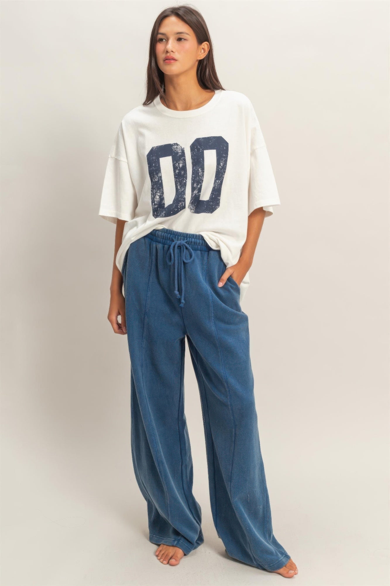 Blue wide-leg French terry pants with elastic waistband and drawstring ties