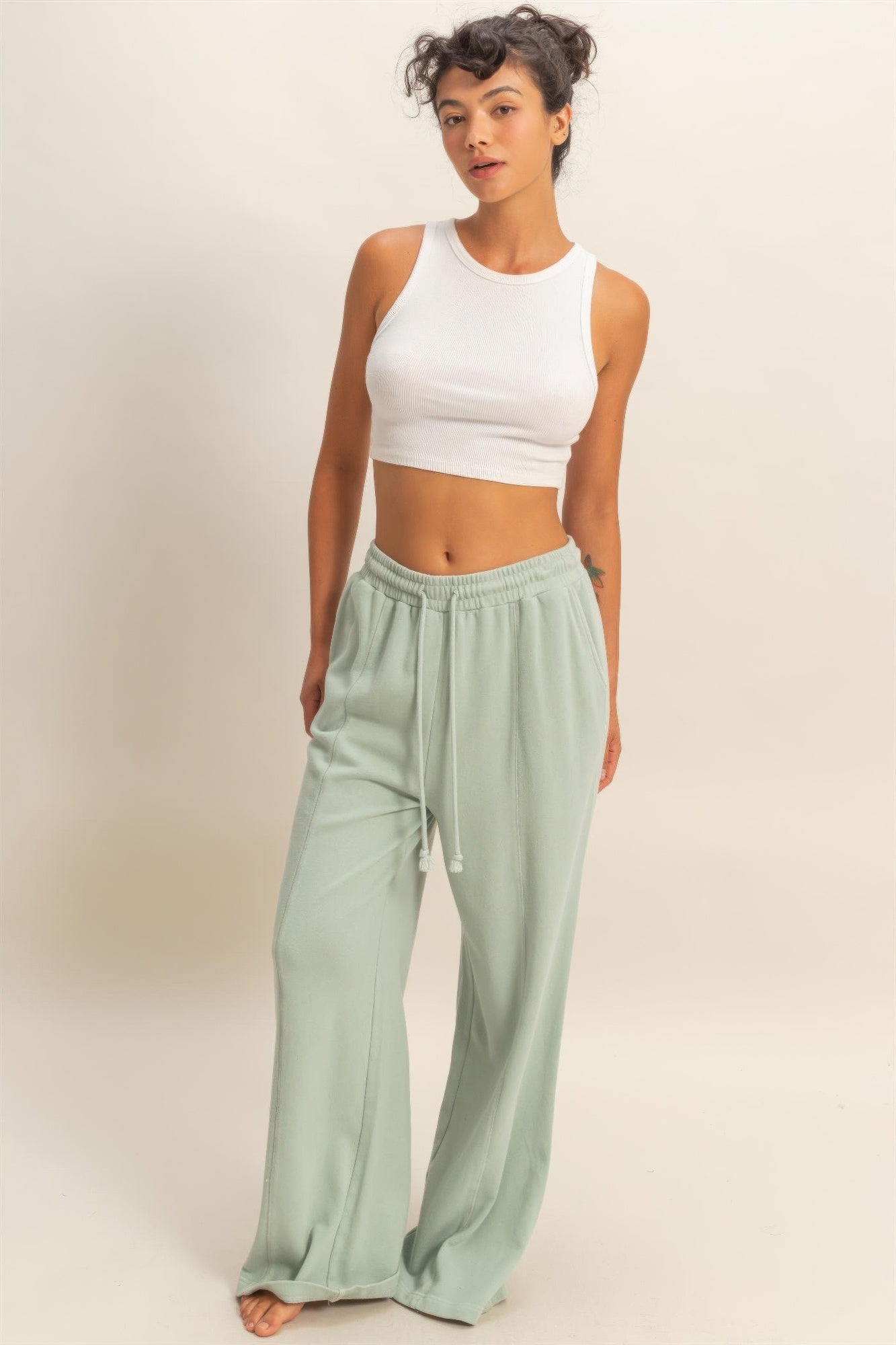 Mint green wide-leg sweatpants with elastic waistband and drawstring ties, French terry