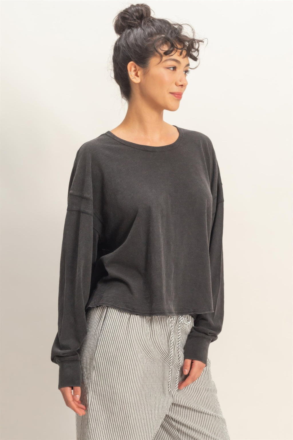 Black long-sleeve top with deep open back and cross wrap detail