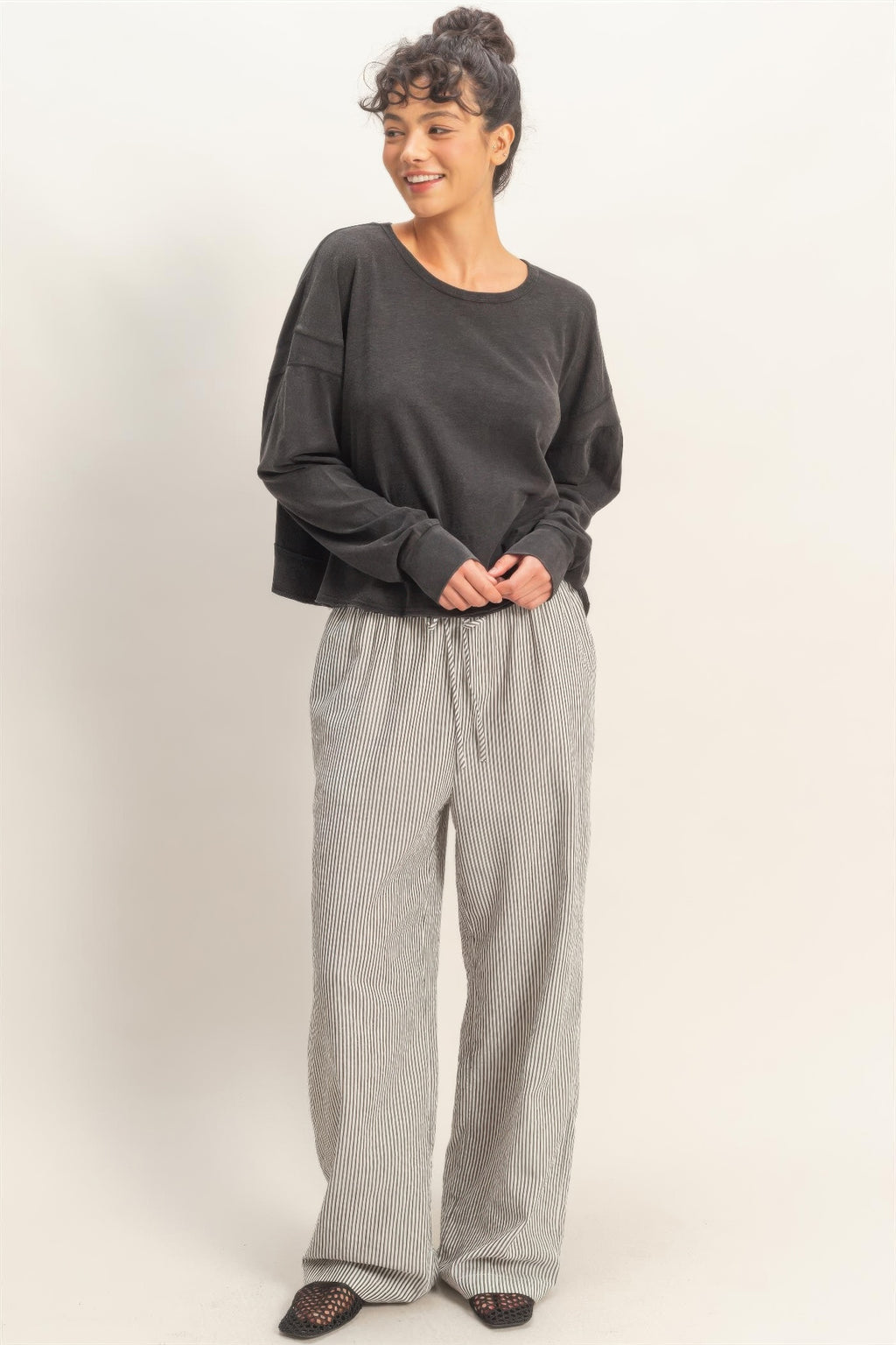 Black long-sleeve top with crew neck; open back cross detail
