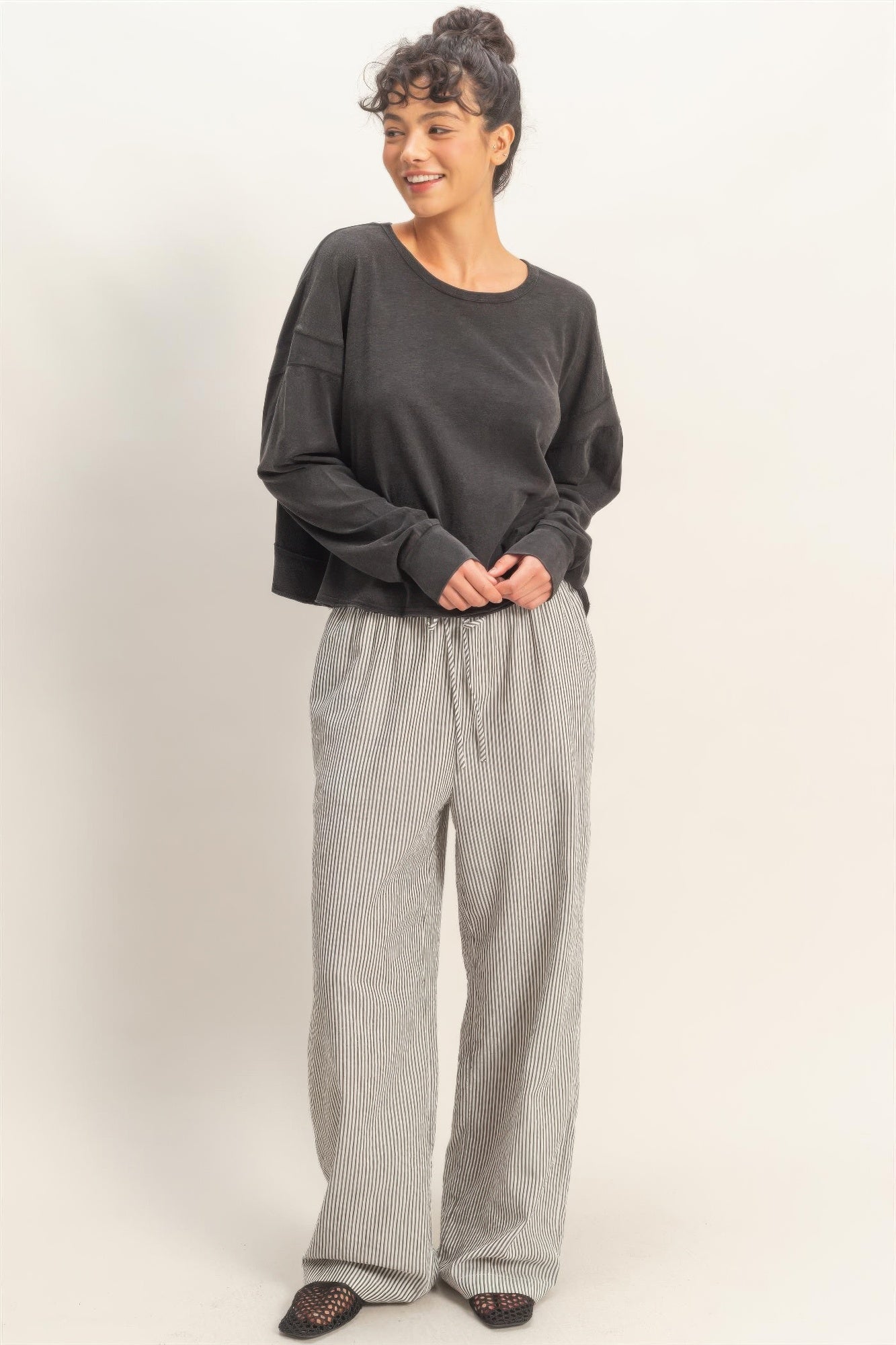 Black long-sleeve top with crew neck; open back cross detail
