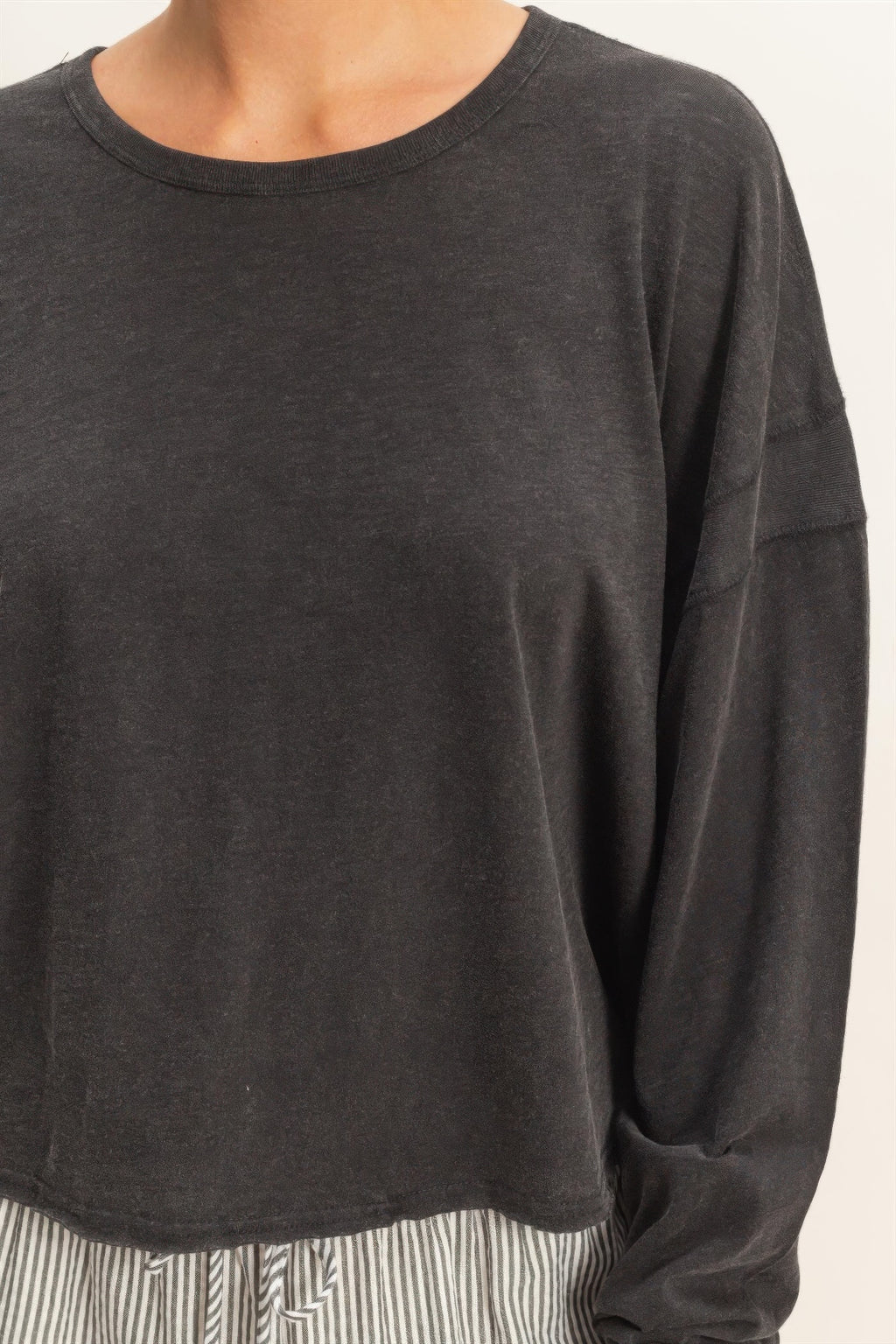 Black long-sleeve crew top with back cross-over cutout (partial view)
