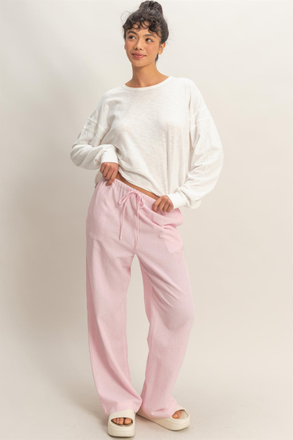 White long-sleeve top with crew neck and relaxed silhouette