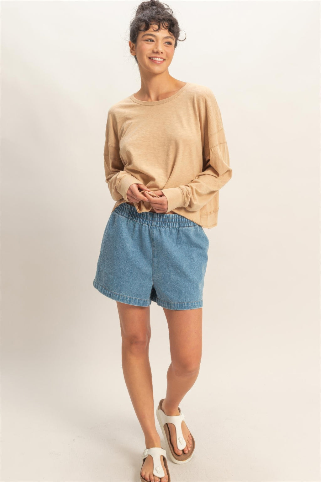 Cross-detail open-back long-sleeve top in dark taupe, loose fit with wide cuffs