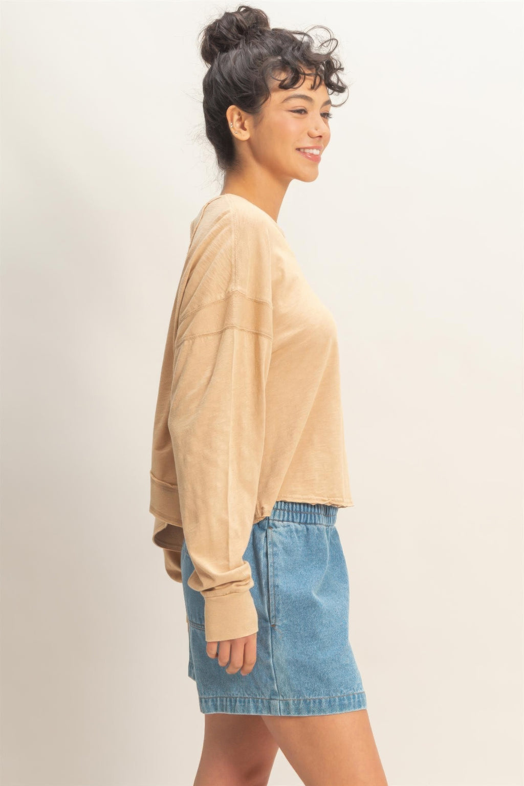 Dark taupe long-sleeve top, open back with crisscross straps and relaxed silhouette