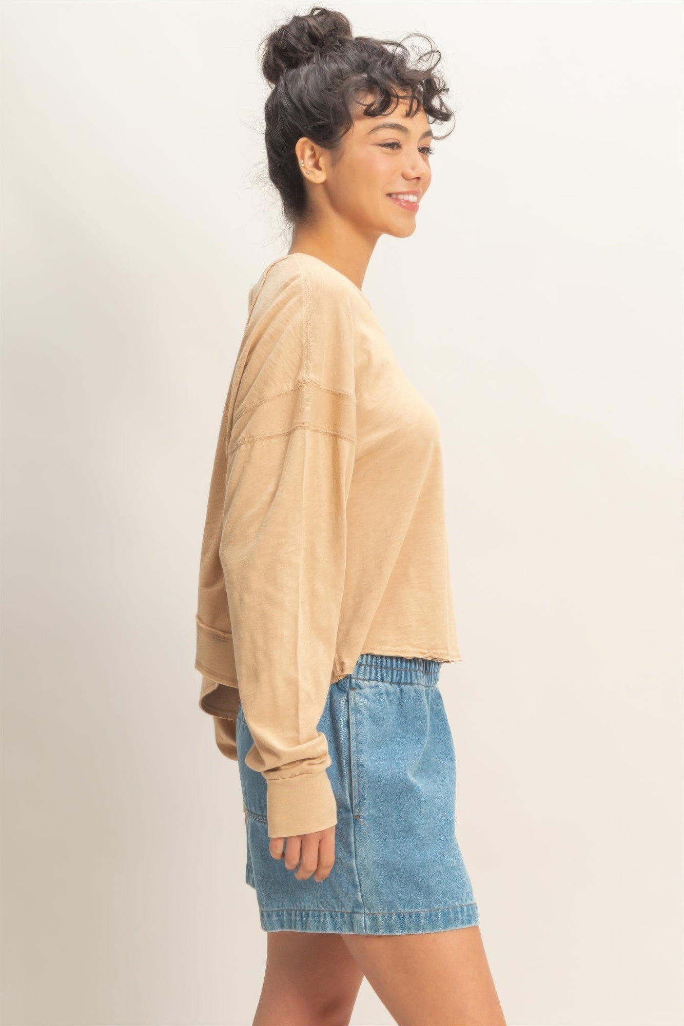 Dark taupe long-sleeve top, open back with crisscross straps and relaxed silhouette