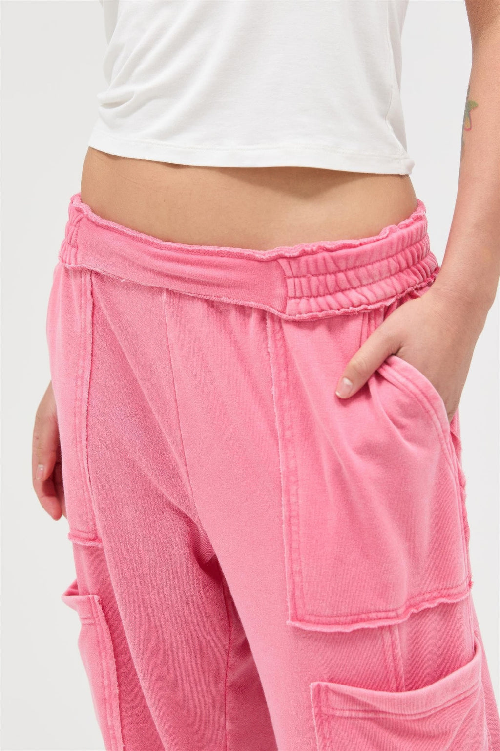 Taffy pink wide-leg cargo pants, waistband and front pocket detail close-up