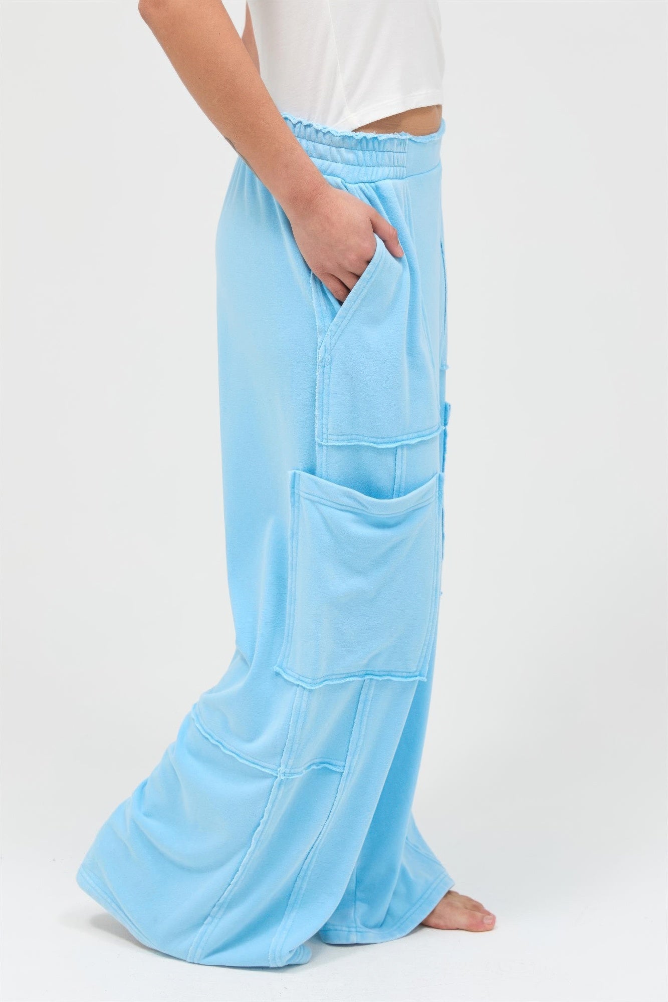Turquoise blue wide-leg cargo pants with front flap pockets and relaxed straight legs