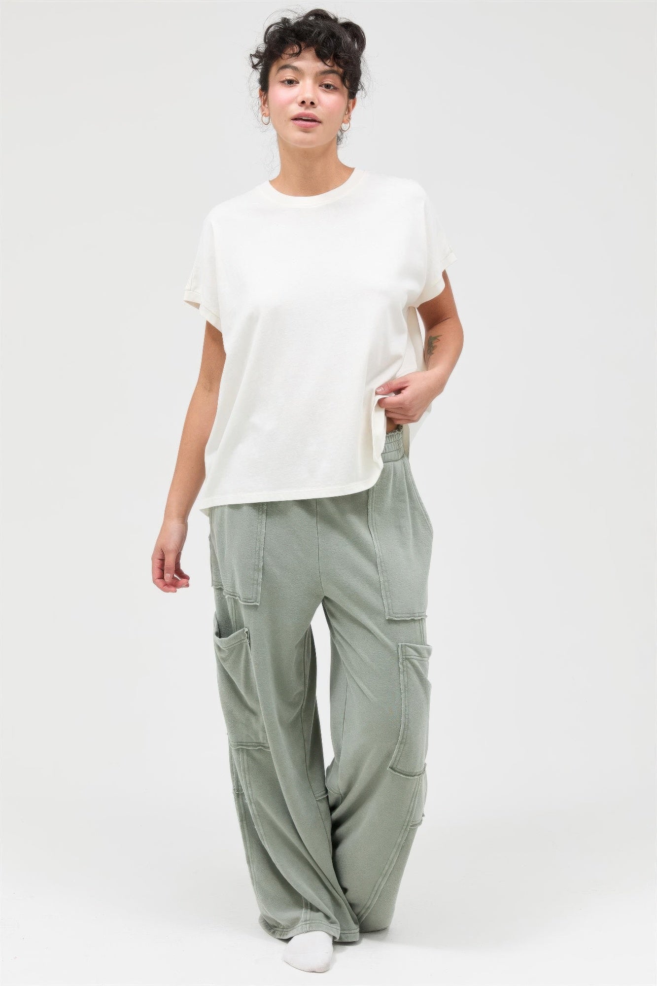 Sage green wide-leg cargo pants with side cargo pockets and relaxed drape
