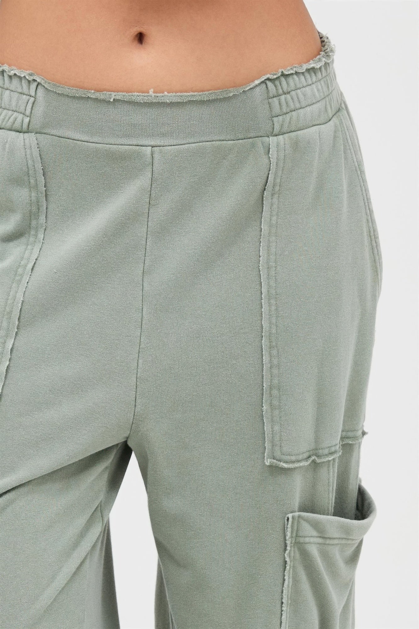 Sage green wide-leg cargo pants, elastic waistband and side cargo pocket with flap