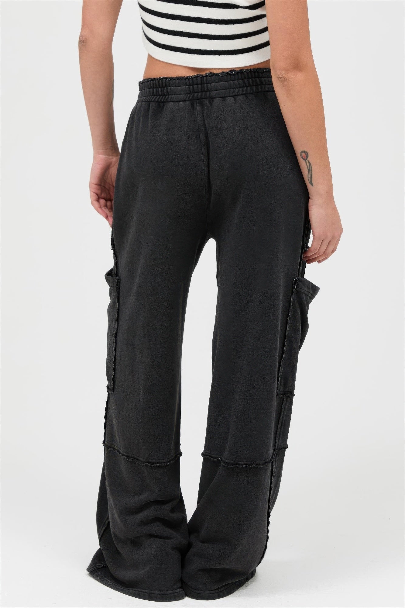 Black mineral-wash wide-leg cargo pants, patch pockets at sides, loose straight legs
