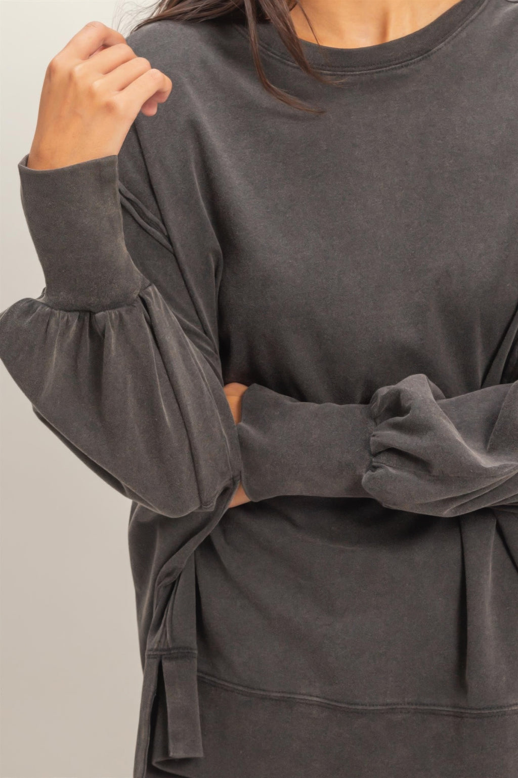 Black oversized long sleeve top, relaxed fit with gathered cuffs and seam detail