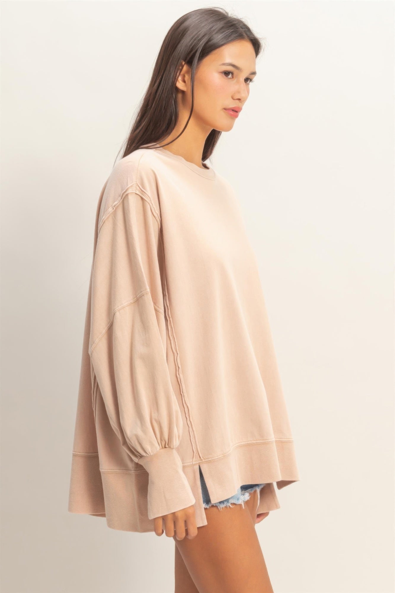 Taupe oversized long sleeve top, side view showing loose fit and seam detail