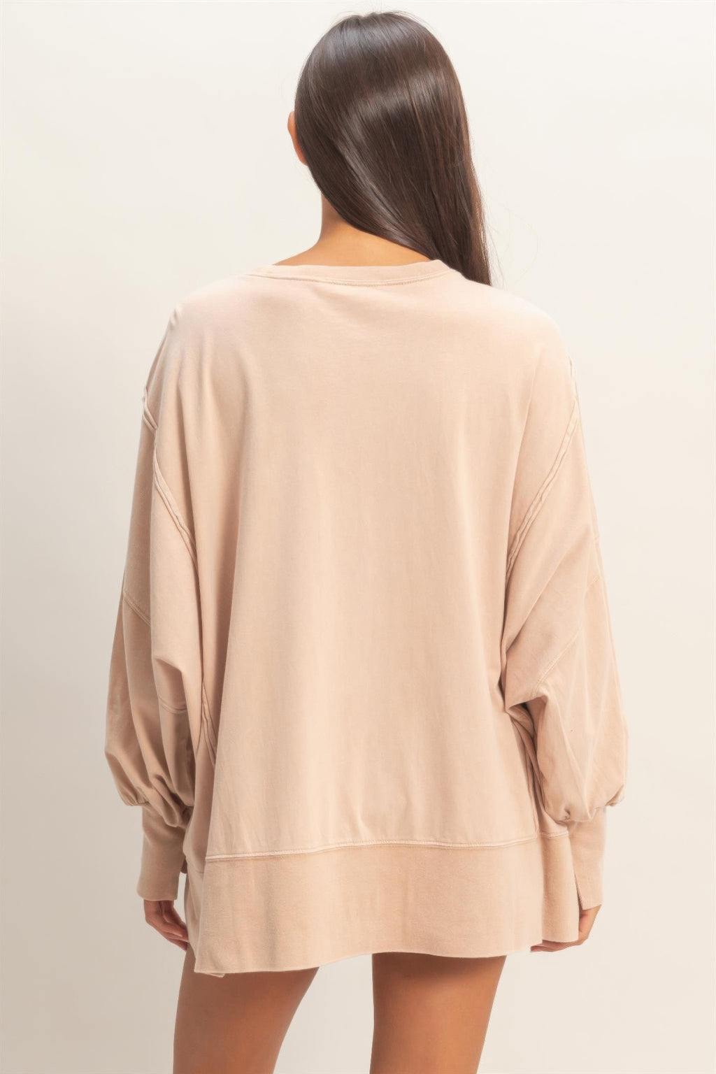 Back view of taupe oversized long sleeve top with dropped shoulders and seam panels