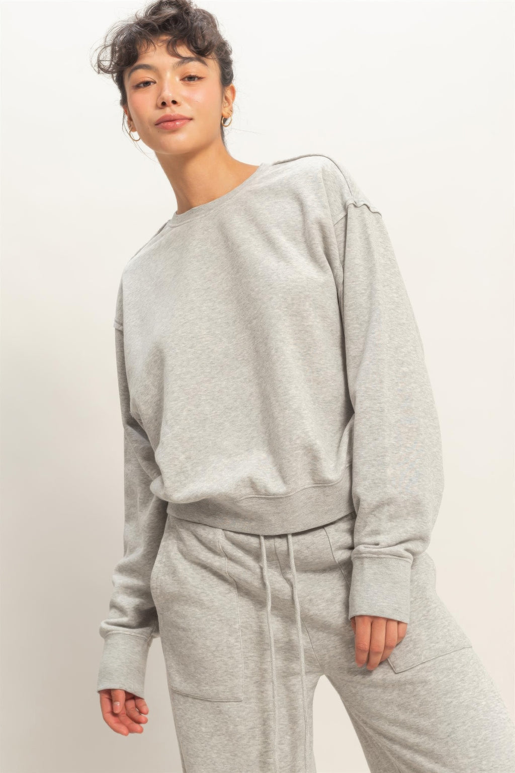 Heather grey burnout sweatshirt side view with raw-edge shoulder and long sleeves