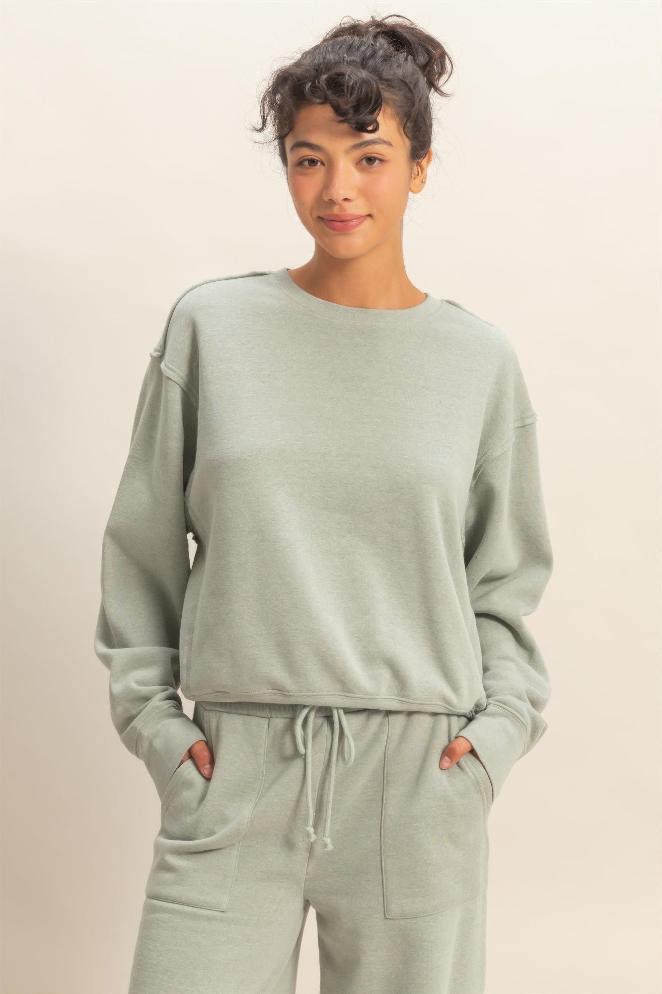 Heather grey raw-edge sweatshirt with crew neck and relaxed long sleeves