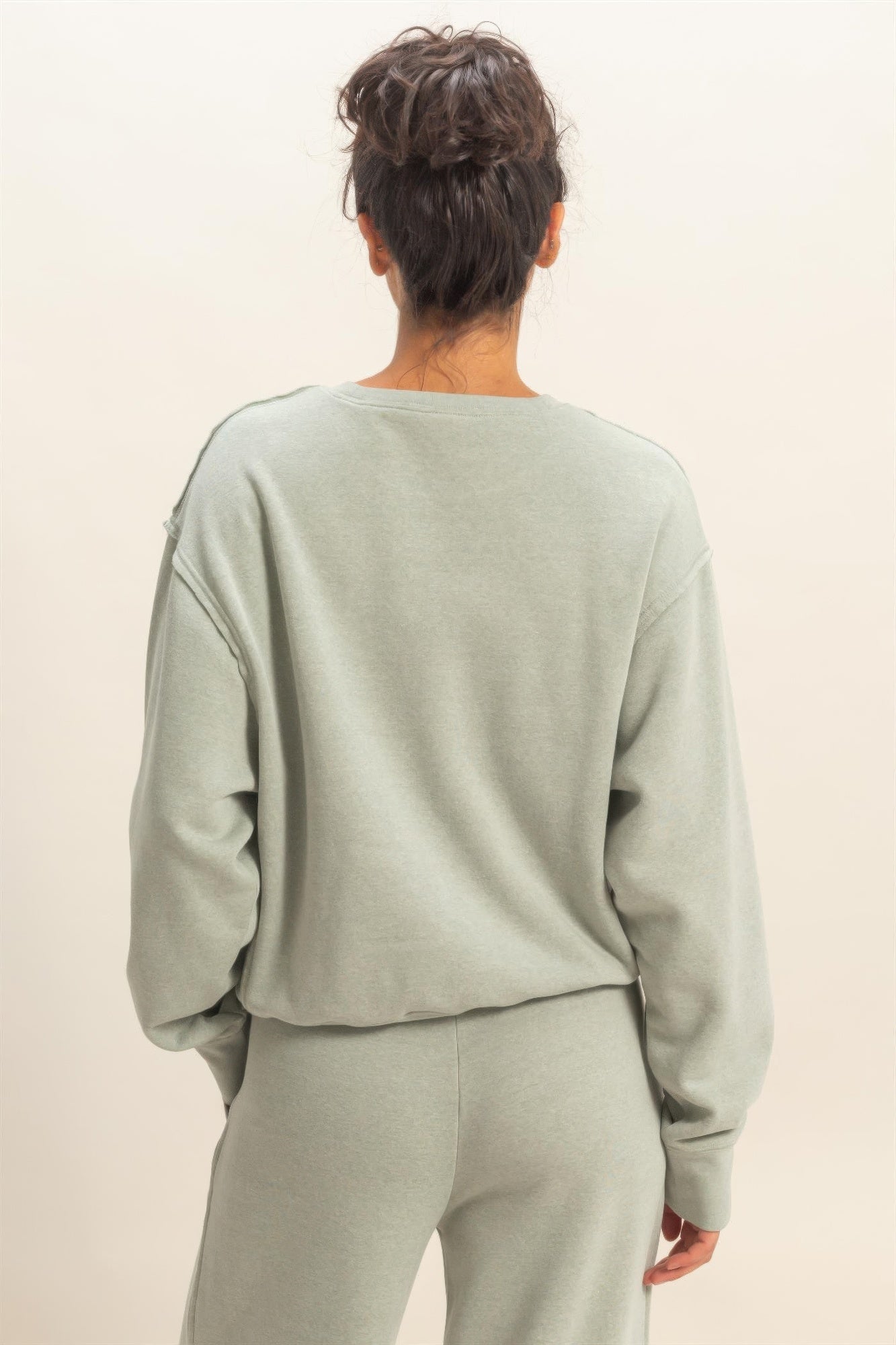 Heather grey raw-edge sweatshirt back view with crew neck and roomy sleeves