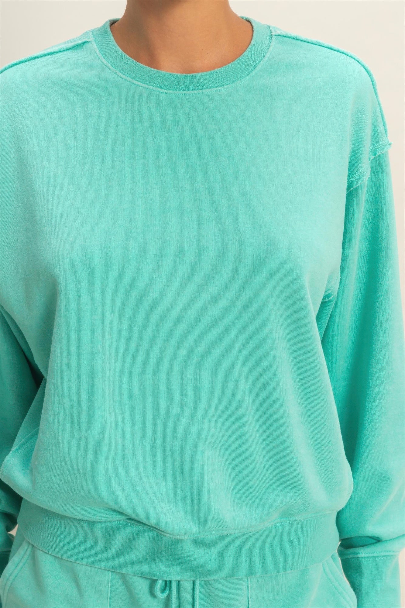 Turquoise burnout sweatshirt crew neck with raw-edge detail on collar
