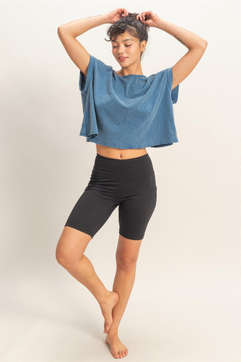 Blue open-back cross-detail top with wide neckline and drapey short sleeves