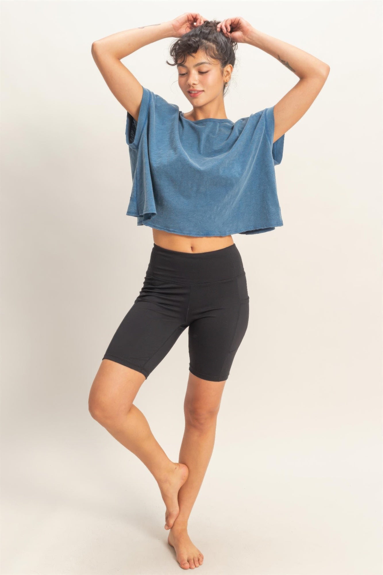 Blue open-back cross-detail top with wide neckline and drapey short sleeves