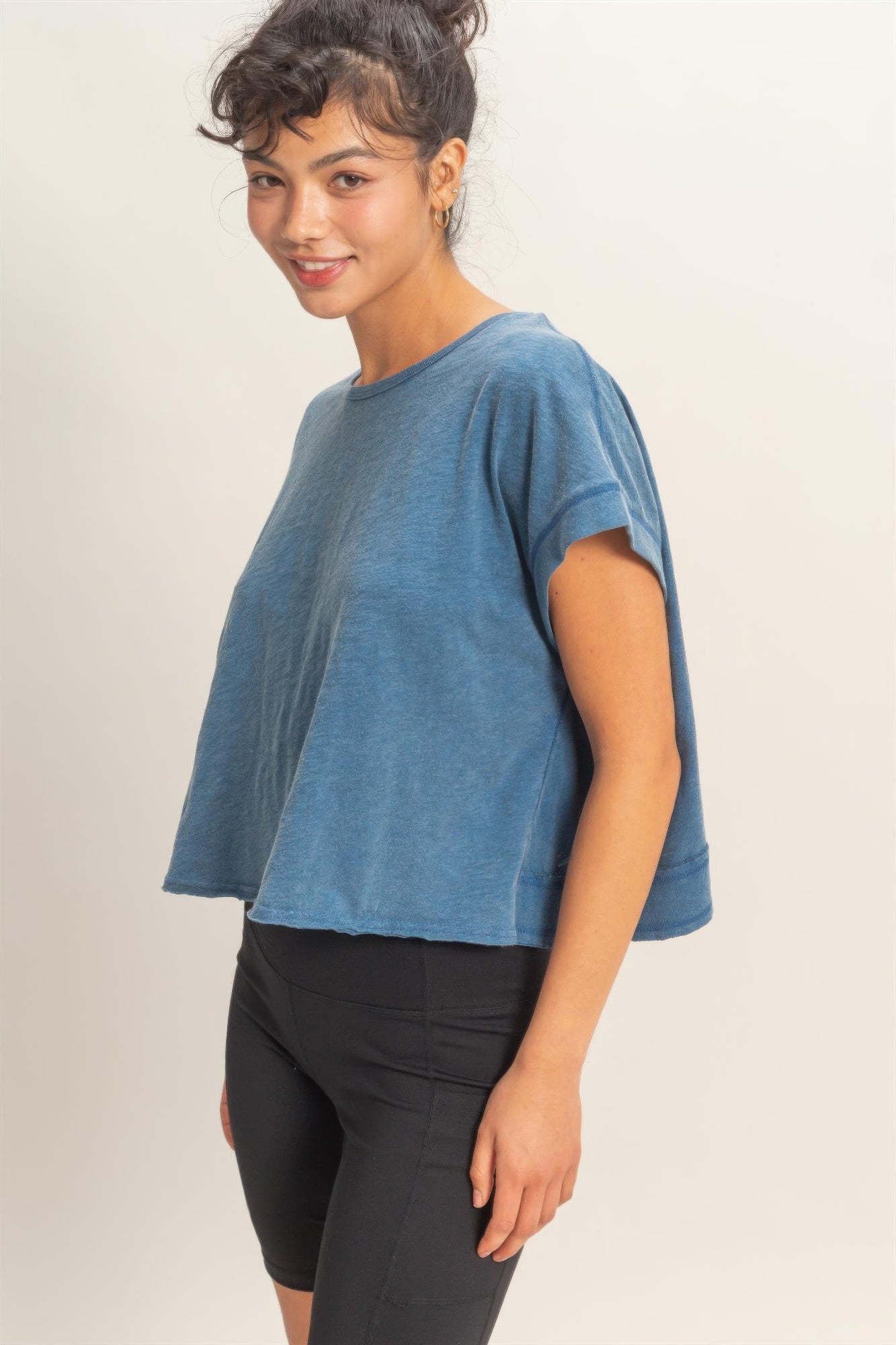 Blue acid-washed short-sleeve top with simple front and relaxed, cropped length
