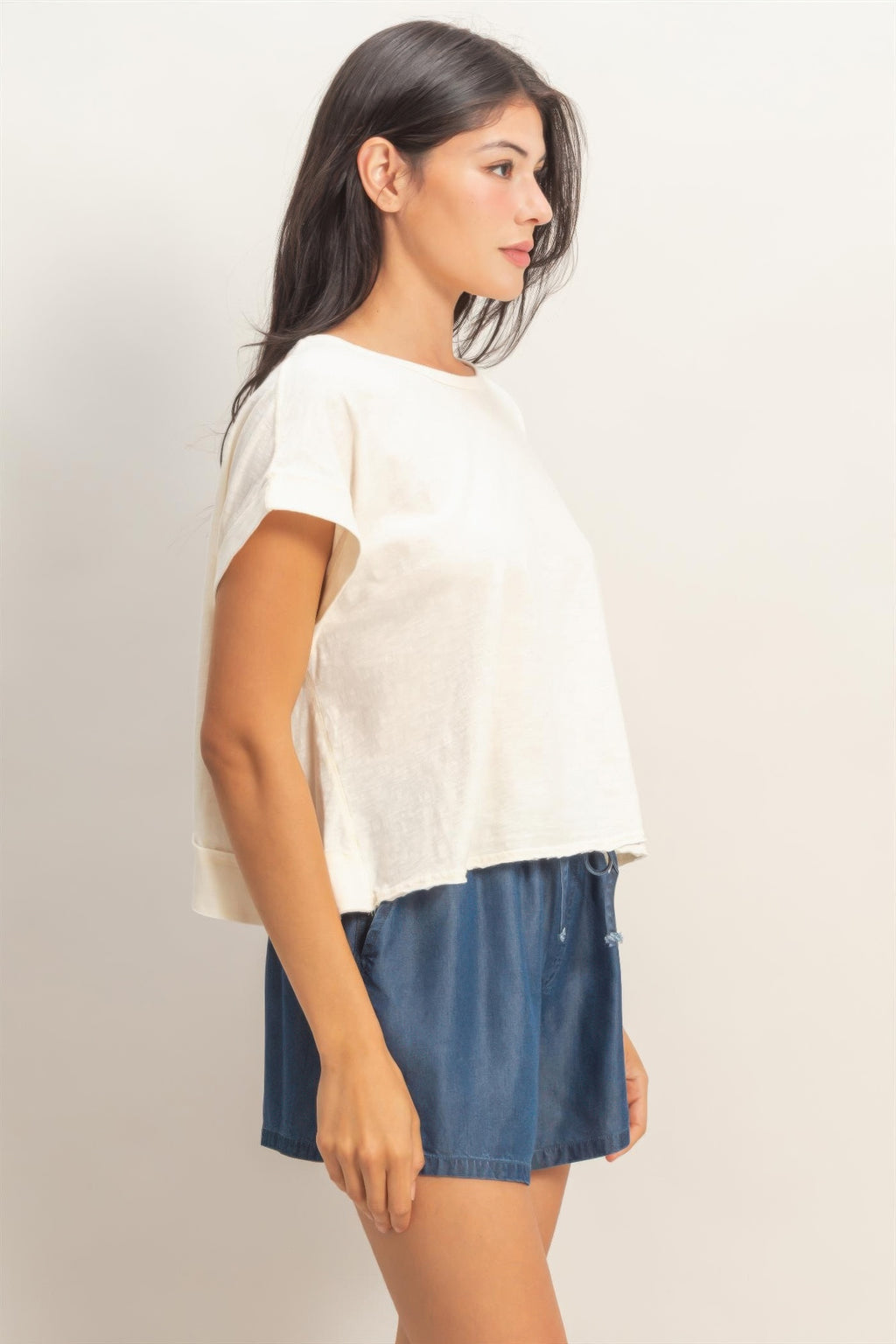 White open-back cross-detail top with short sleeves and acid-washed texture