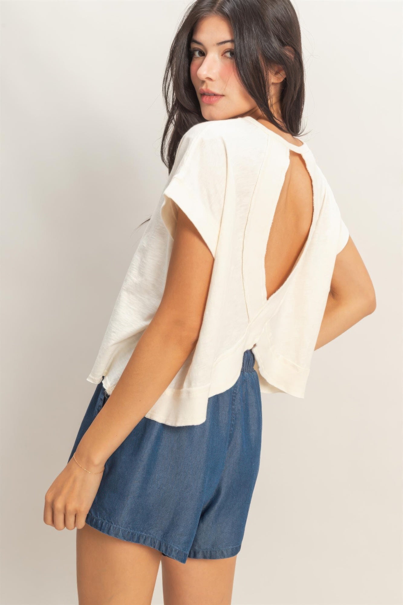 White top with open back cross detail and loose, slightly oversized silhouette