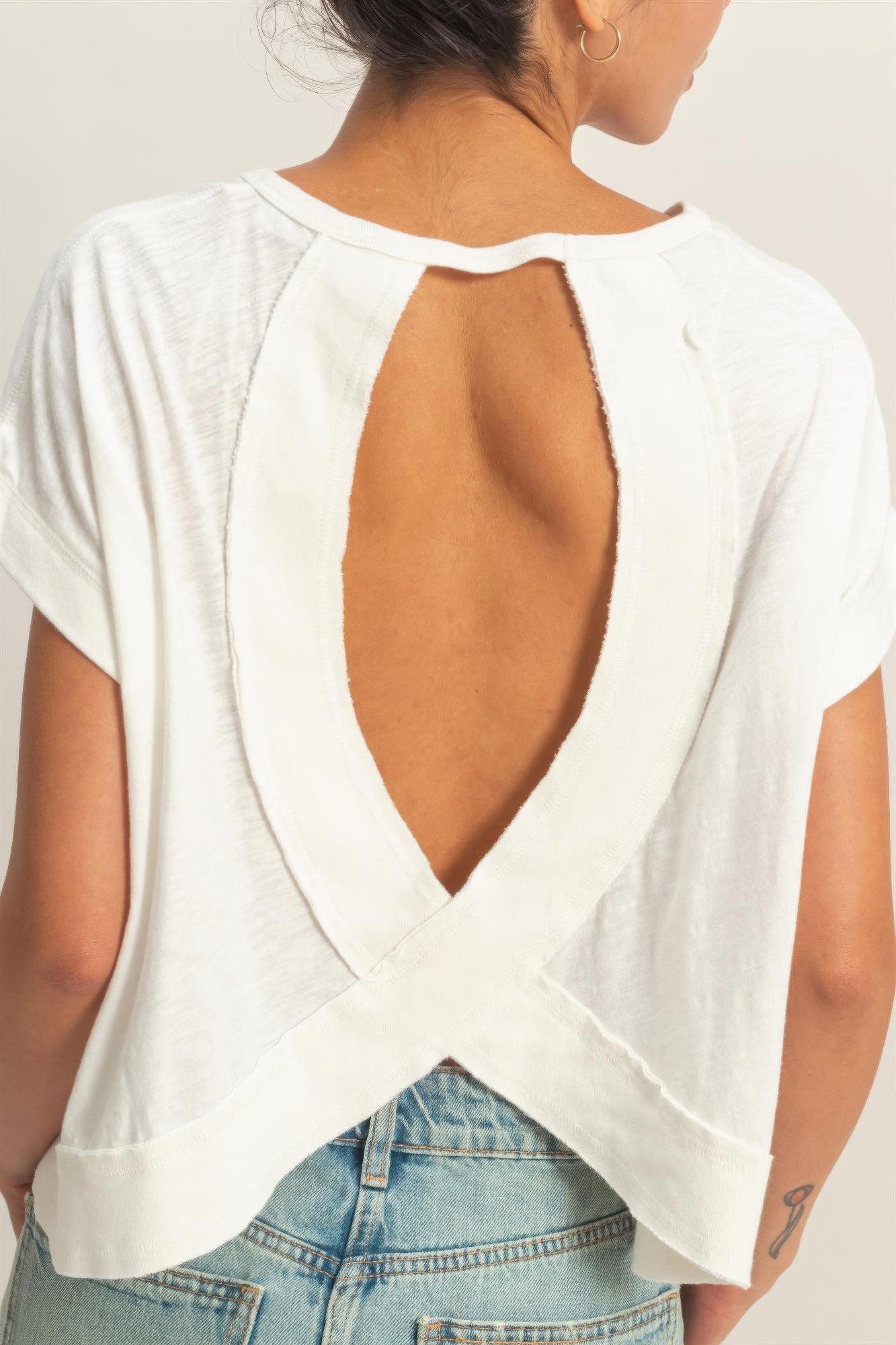 White cross-detail open-back top, back neckline cutout and crossed panel detail