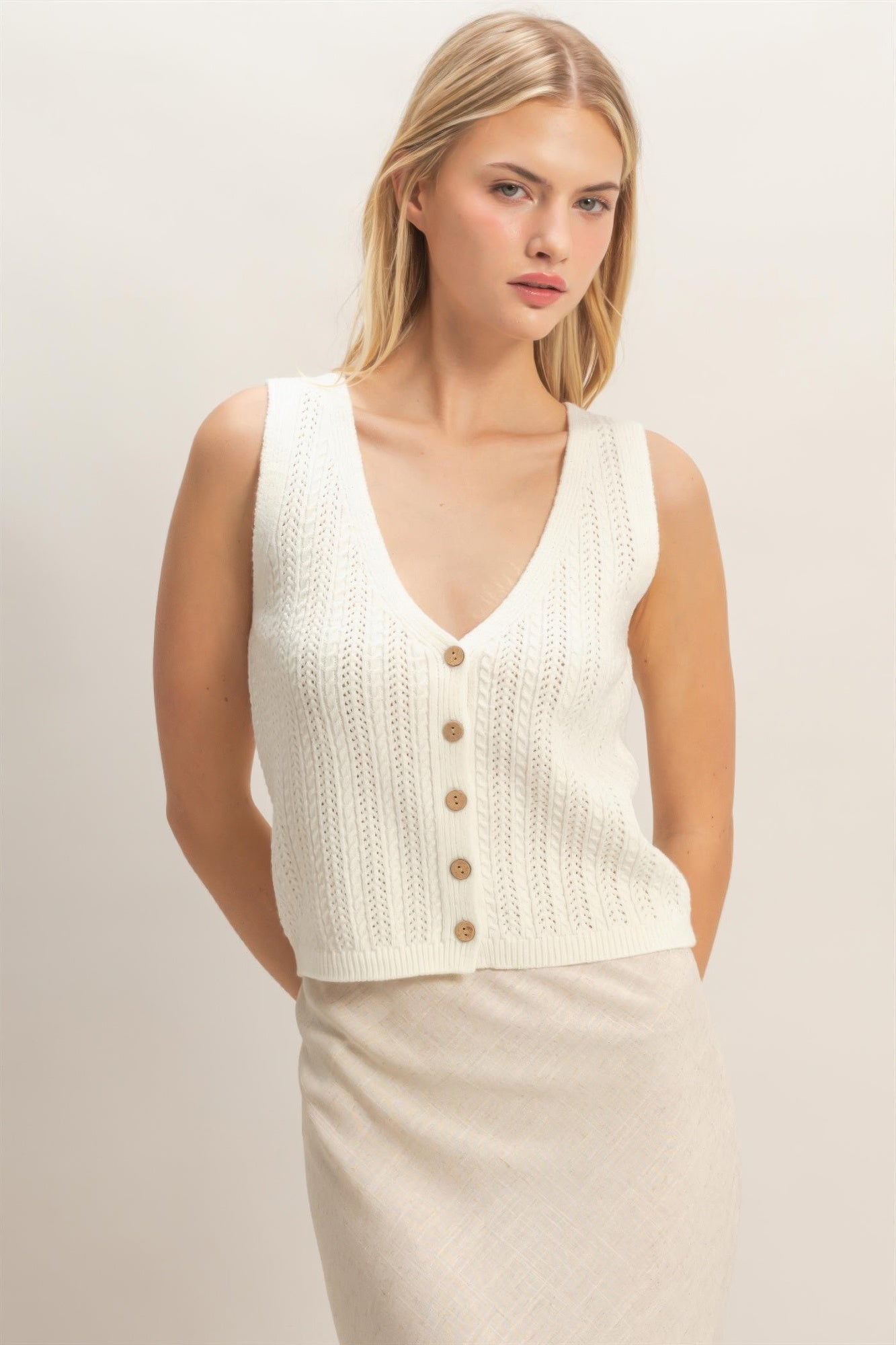 Off-white V-neck knit tank with button placket, sleeveless