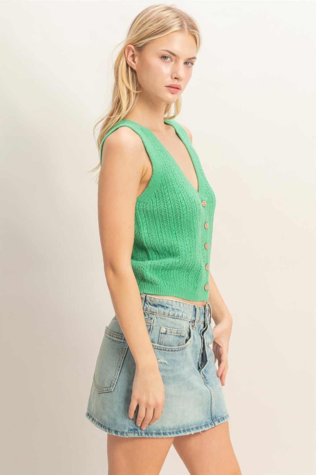 Green sleeveless V-neck knit tank top with button placket and fitted waist hem