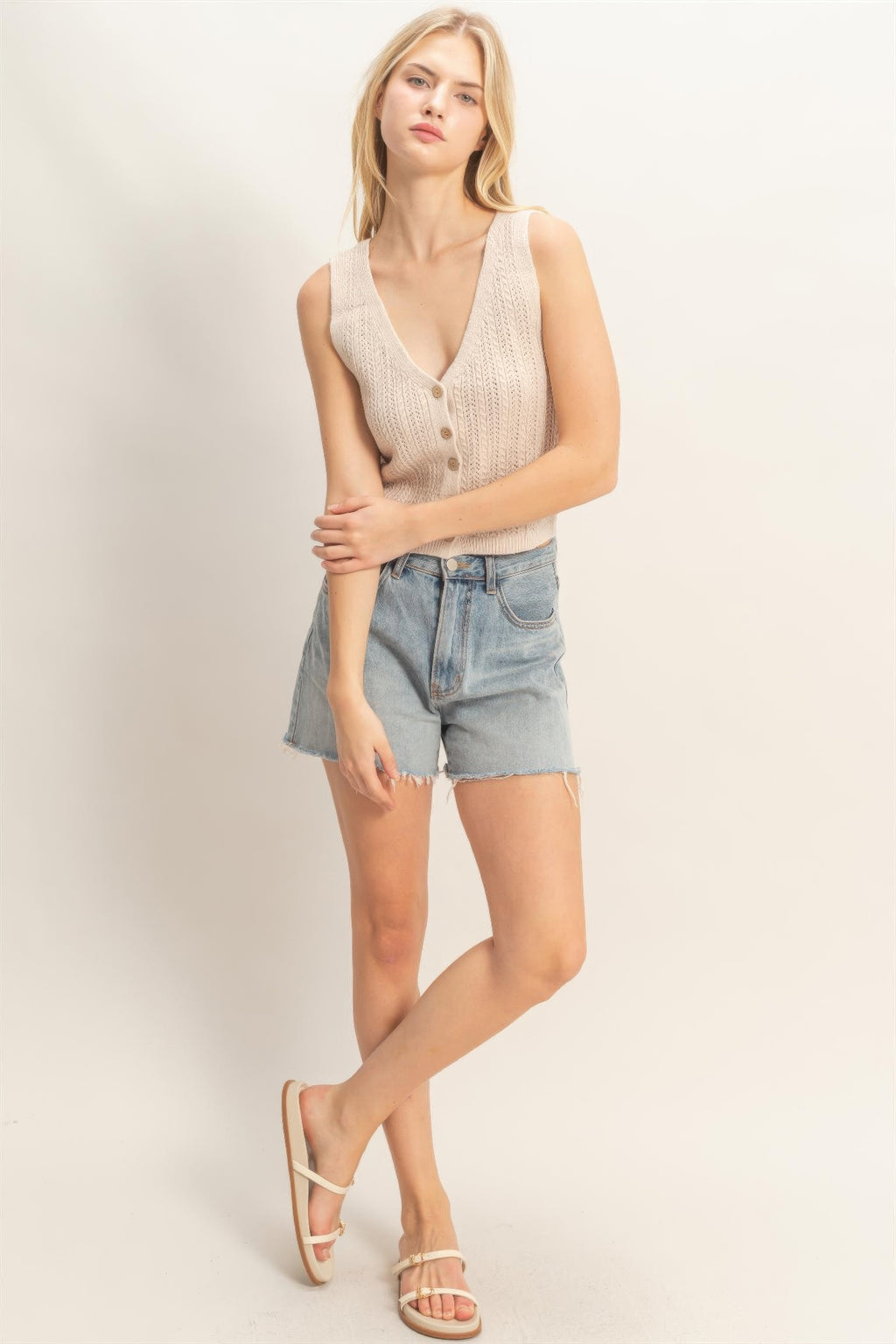 Off-white V-neck knit tank top with vertical button placket and slim shoulder straps