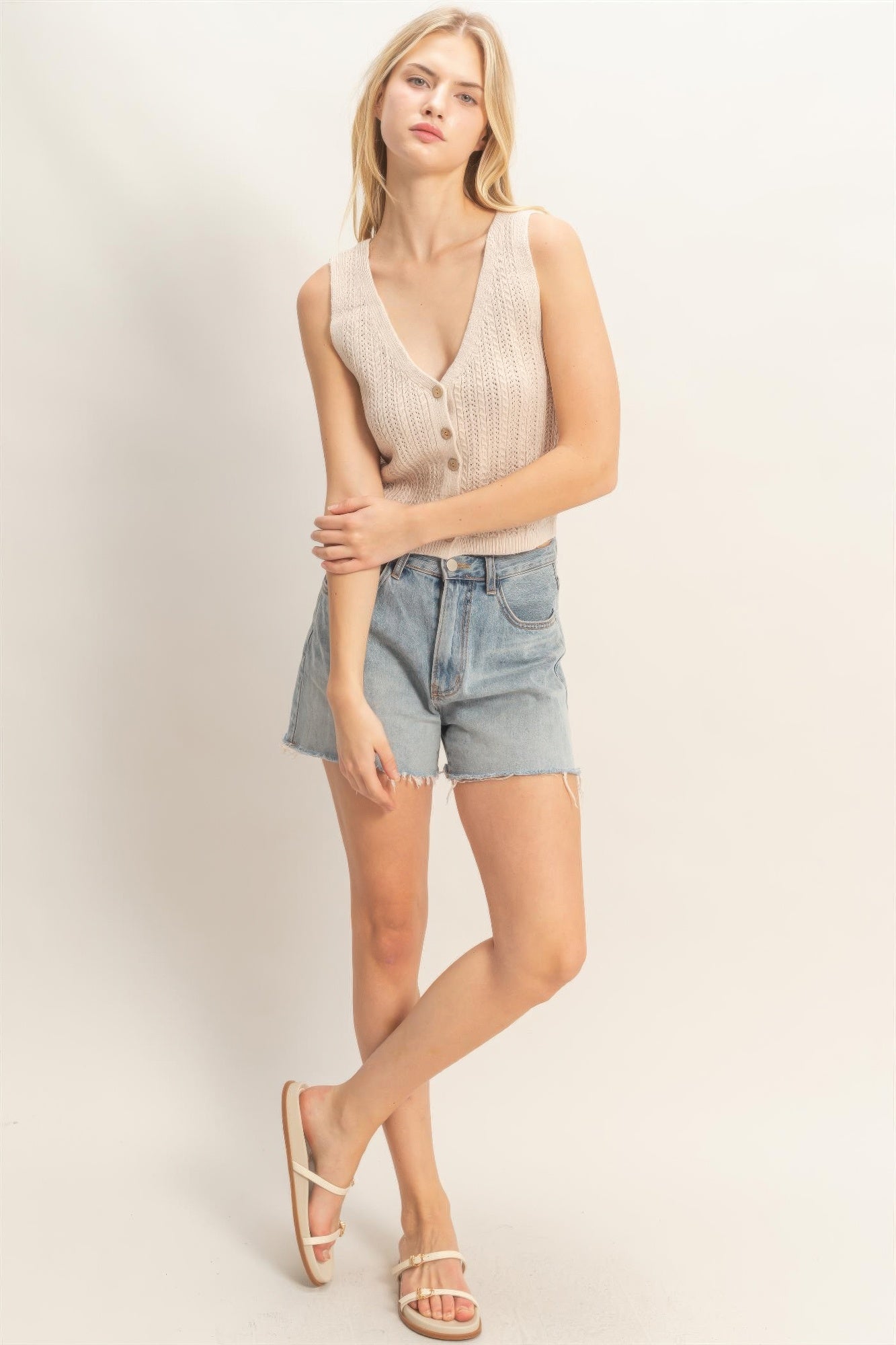 Off-white V-neck knit tank top with vertical button placket and slim shoulder straps