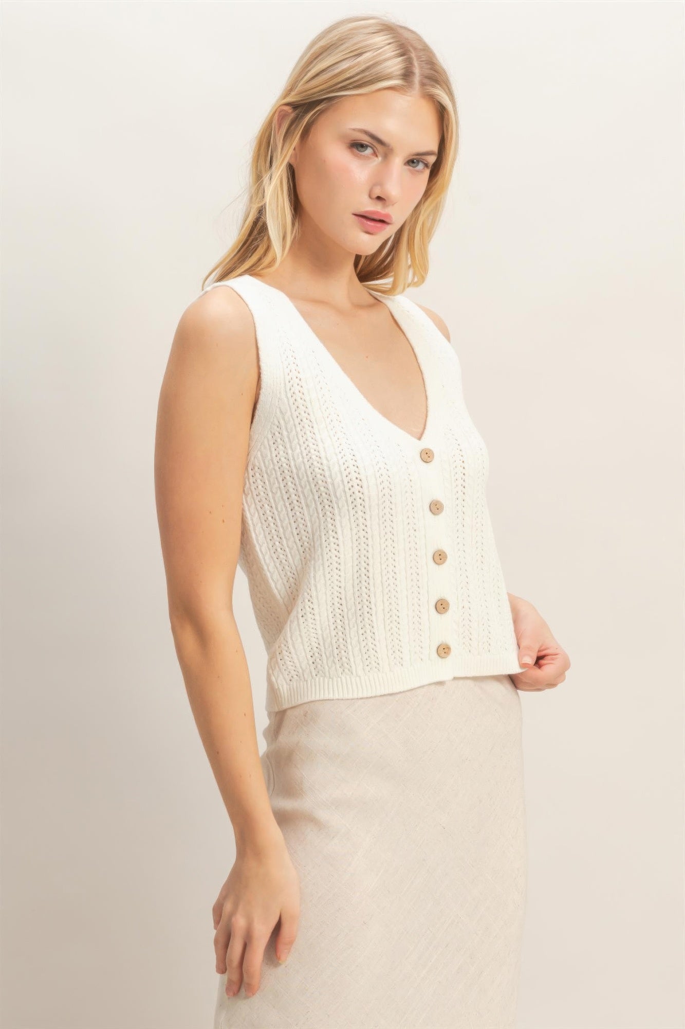 Off-white V-neck knit tank with wooden-look buttons, sleeveless