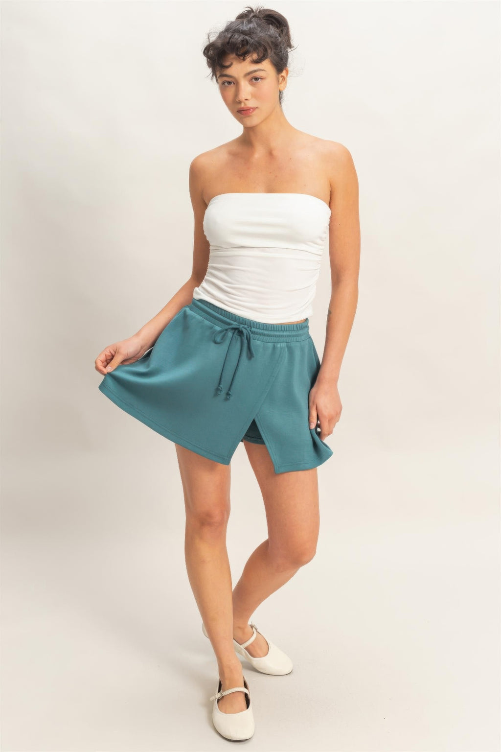 Dark teal skort with elastic waistband, drawstring ties, wrap-style front