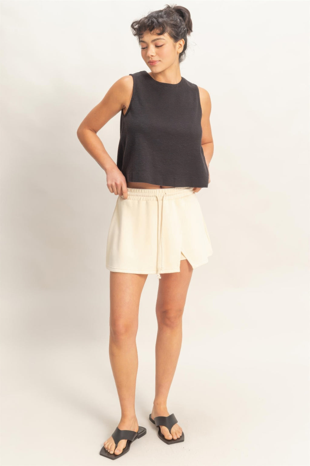 Cream alpaca skort with wrap front slit, elastic waist, and short flared legs