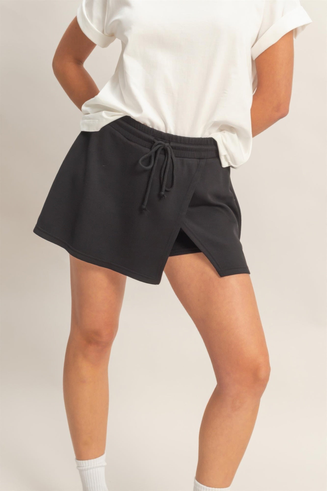 Black wrap-front skort with elastic waist and drawstring ties