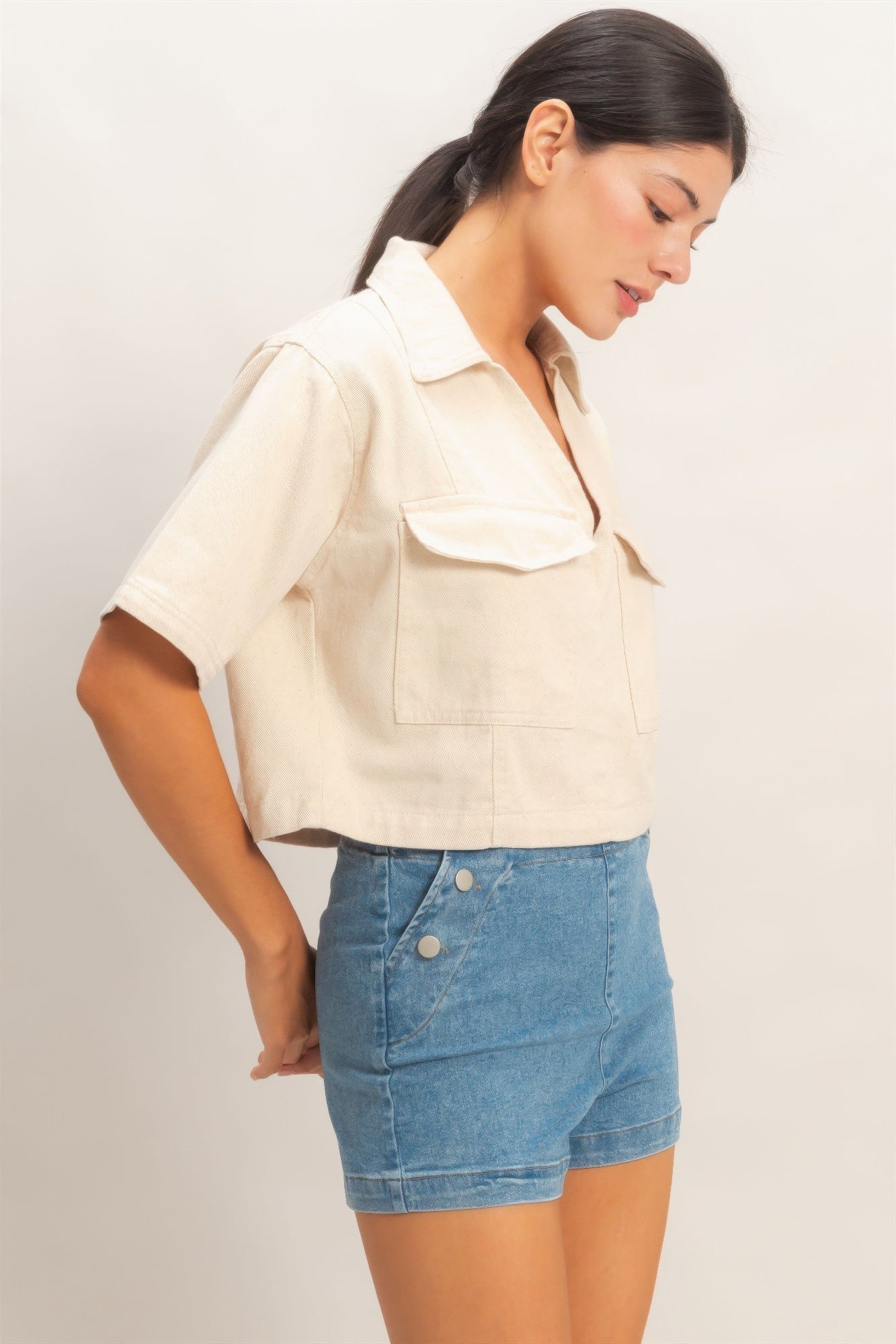 Oatmeal collared V-neck top, angled side view with chest patch pockets