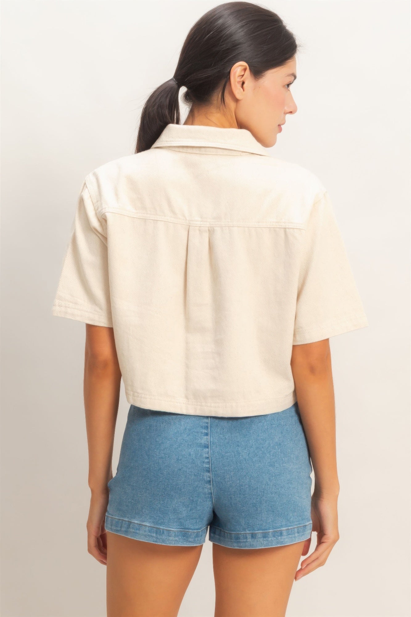 Oatmeal collared V-neck top, back view with short sleeves and yoke seam
