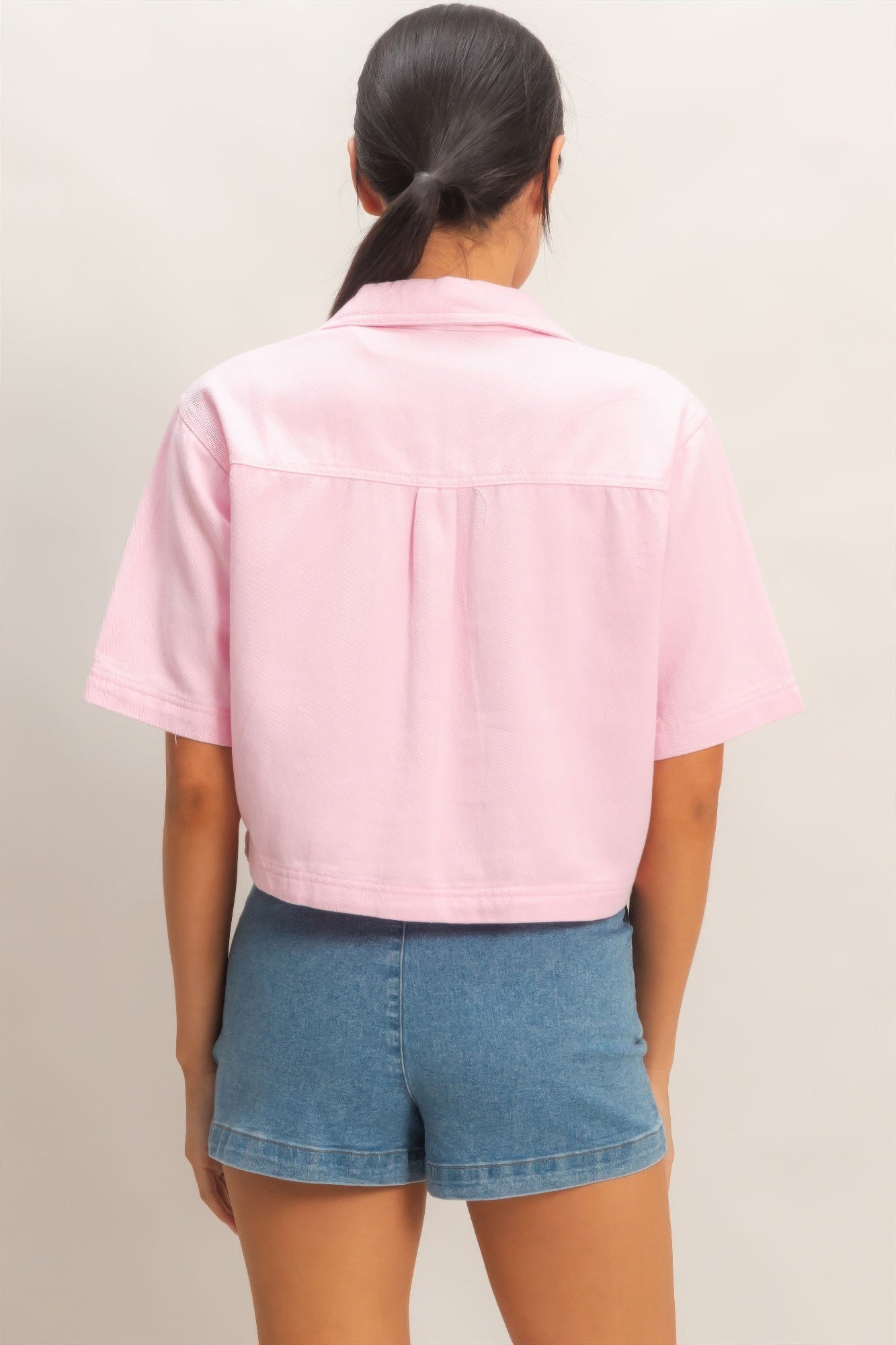 Pink collared V-neck top, back view with yoke seam