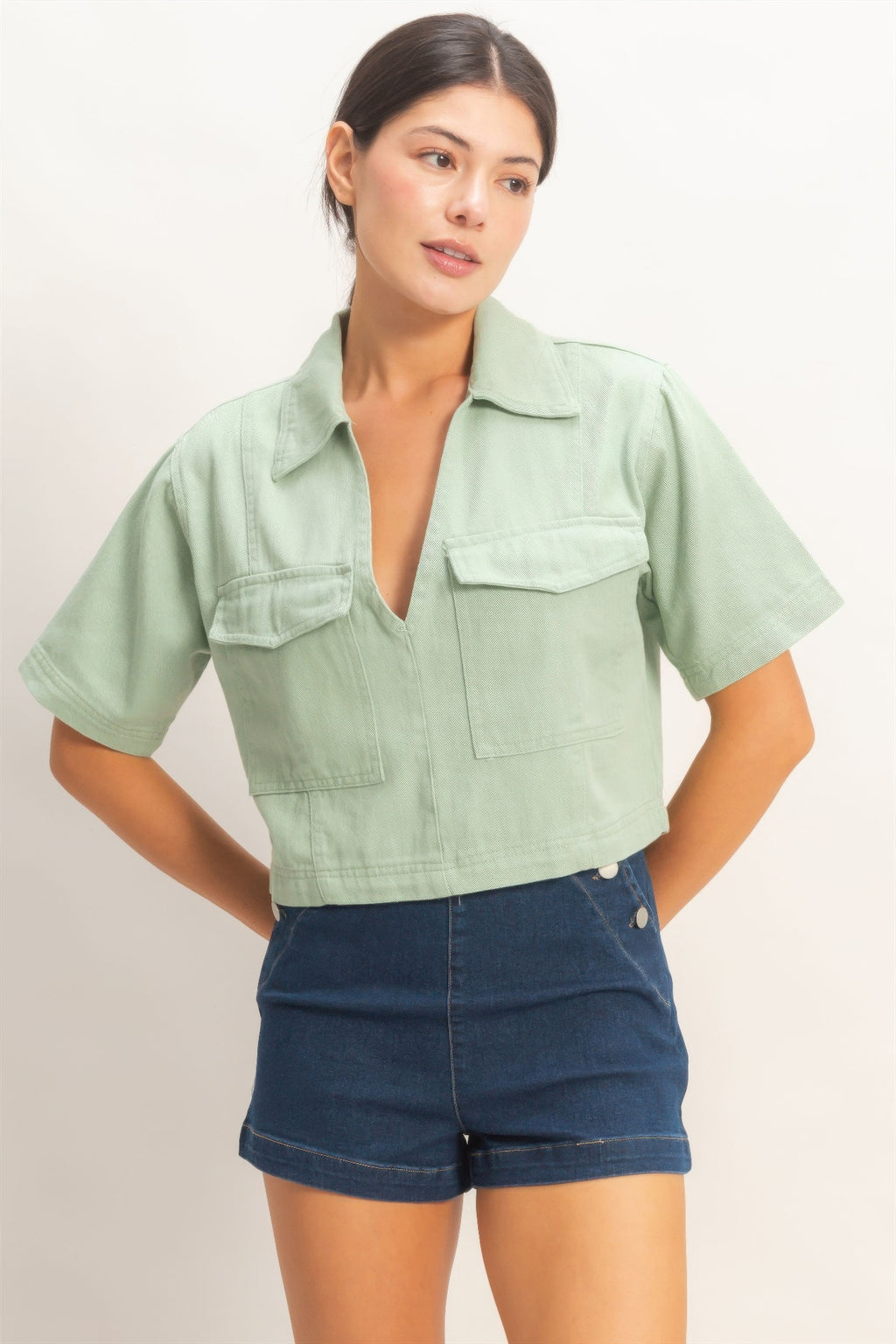 Collared V-neck top in sage green with chest flap pockets