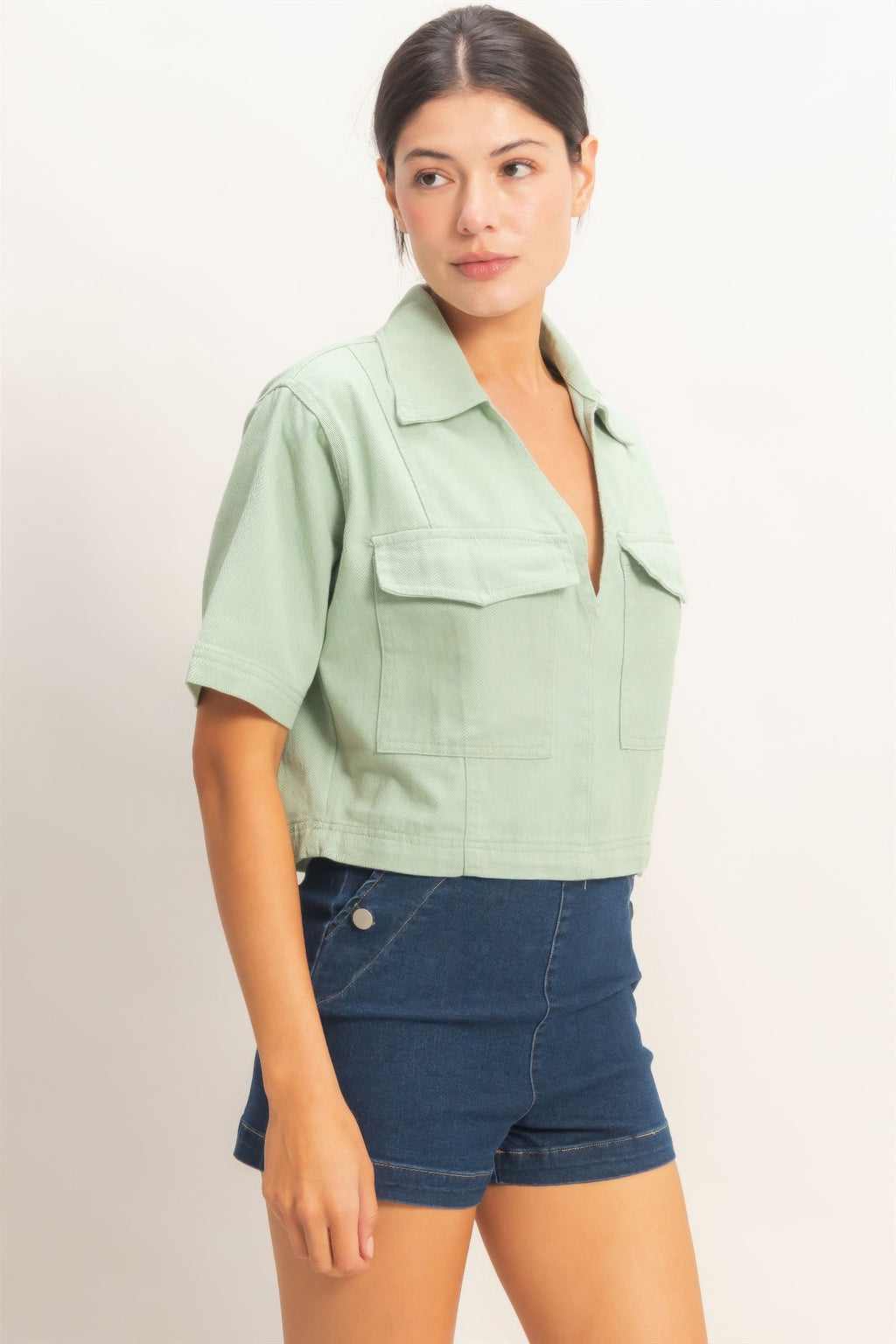 Sage green collared V-neck cropped top with chest flap pockets