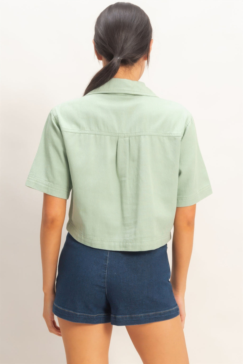 Back view of sage green collared V-neck top
